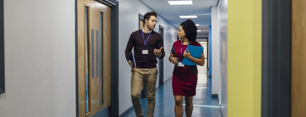 Teachers talking in the hallway of a school